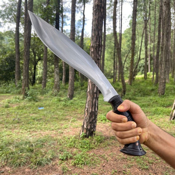 Person holding khukuri in hand with proper grip in handle shining blade showcase